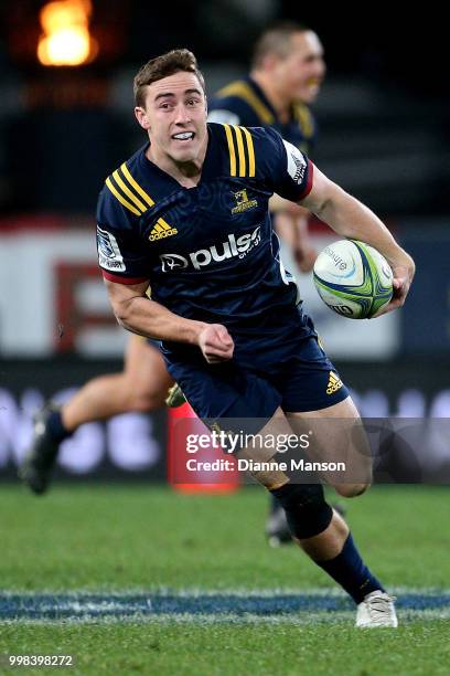 Josh McKay of the Highlanders makes a break during the round 19 Super Rugby match between the Highlanders and the Rebels at Forsyth Barr Stadium on...