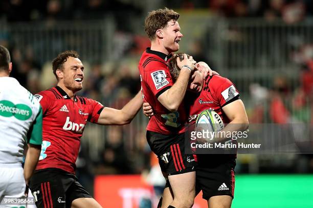 Ryan Crotty, Israel Dagg, Mitchell Drummond and Jack Goodhue all of the Crusaders celebrate after scoring a try during the round 19 Super Rugby match...