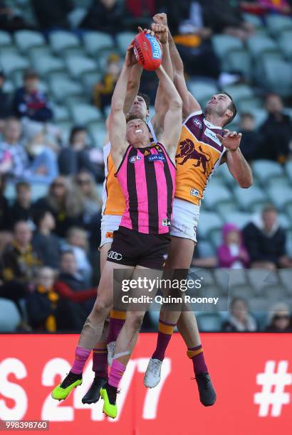 Tim O'Brien of the Hawks marks infront of Josh Walker of the Lions during the round 17 AFL match between the Hawthorn Hawks and the Brisbane Lions at...