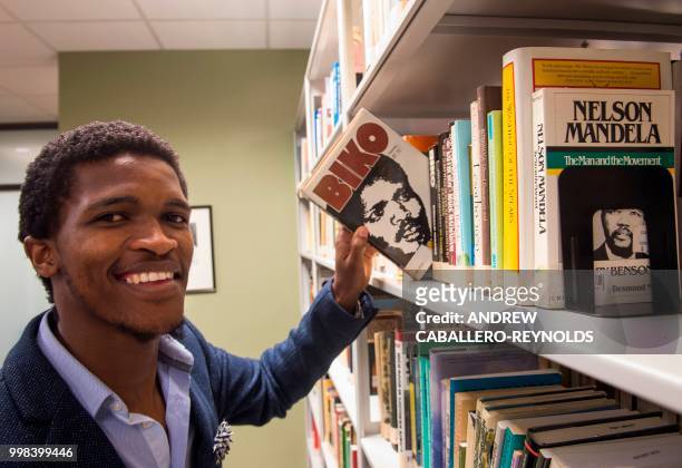 Siyabulela Mandela, grandson of Nelson Mandela, poses during a photo session in a library at George Mason University before an interview with AFP in...