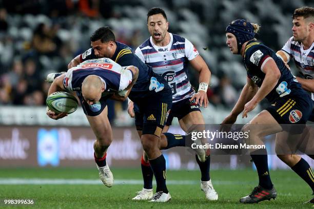 Billy Meakes of the Rebels is tackled by Lima Sopoaga of the Highlanders as Michael Ruru of the Rebels and James Lentjes of the Highlanders look on...