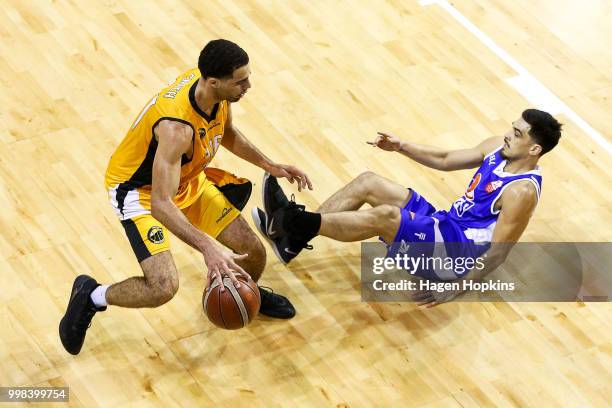 Shea Ili of the Saints loses his footing while defending against Xavier Smith of the Mountainairs during the NZNBL match between Wellington Saints...