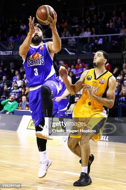 Matt Brien of the Saints shoots under pressure from Xavier Smith of the Mountainairs during the NZNBL match between Wellington Saints and Taranaki...