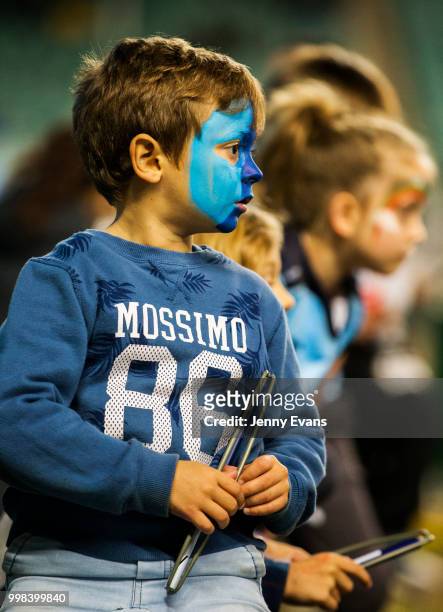 Waratah fans with painted faces watch on as the Waratahs come on to the field for a warm up before the round 19 Super Rugby match between the...