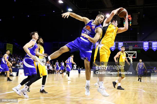 Shane Temara of the Saints and Thane O'Leary of the Mountainairs compete for a rebound during the NZNBL match between Wellington Saints and Taranaki...