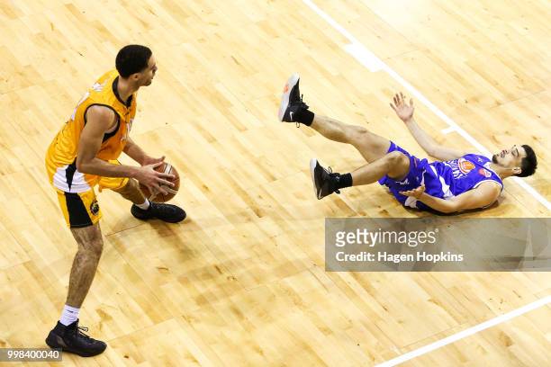 Shea Ili of the Saints loses his footing while defending against Xavier Smith of the Mountainairs during the NZNBL match between Wellington Saints...