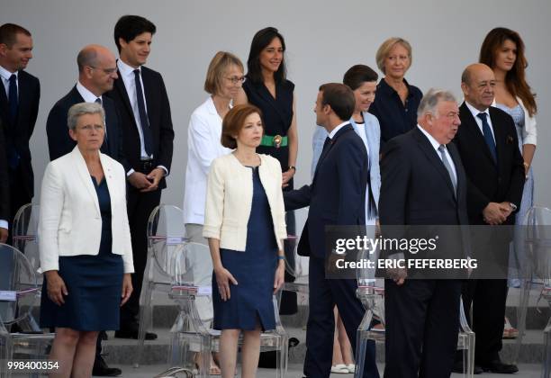 French President Emmanuel Macron greets French Junior Minister for Public Administration Olivier Dussopt, French Education Minister Jean-Michel...
