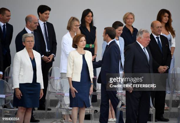 French President Emmanuel Macron greets French Junior Minister for Public Administration Olivier Dussopt, French Education Minister Jean-Michel...