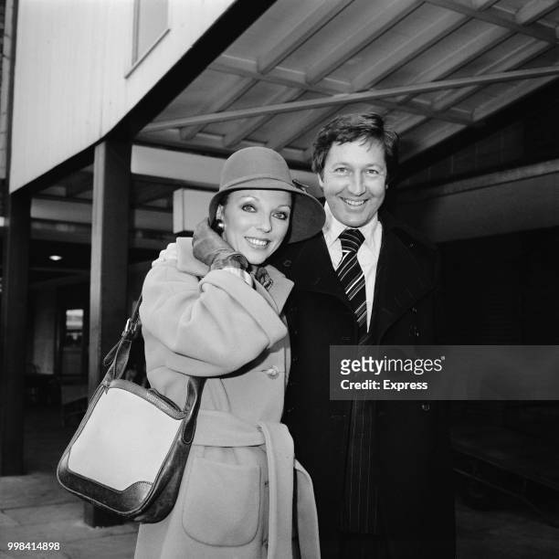English actress Joan Collins pictured with her husband, American businessman Ron Kass on 20th November 1973.