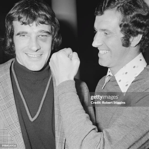 English footballer and forward with Chelsea FC, Peter Osgood raises his clenched fist in jest to the face of Peter Storey of Arsenal in London on...