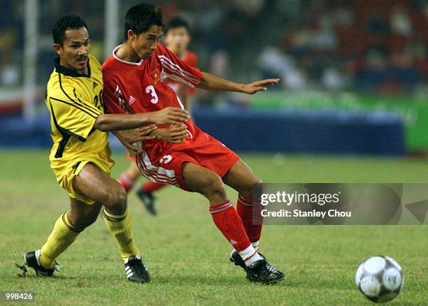 Hairuddin Omar of Malaysia challenging Vu Nhu Thanh of Vietnam in a Group A Men's Under-23 Match held at the National Stadium, Bukit Jalil, Kuala...