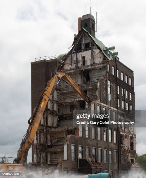 partly demolished large building and mechanical arm - gary colet stock pictures, royalty-free photos & images