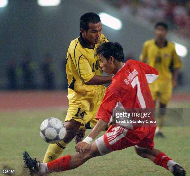 Akmal Rizal of Malaysia slots the ball pass Nguyen Huy Hoang of Vietnam in a Group A Men's Under-23 Match between Malaysia and Vietnam held at the...