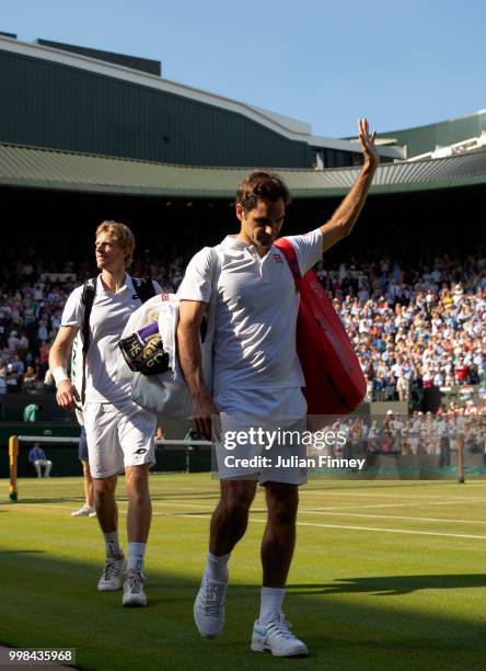 Roger Federer of Switzerland thanks the crowd after losing his Men's Singles Quarter-Finals match against Kevin Anderson of South Africa on day nine...