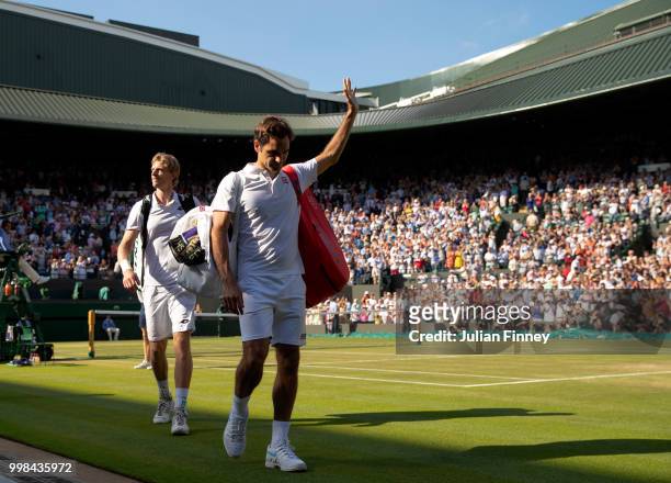 Roger Federer of Switzerland thanks the crowd after losing his Men's Singles Quarter-Finals match against Kevin Anderson of South Africa on day nine...