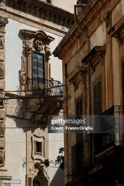 Baroque balcony in a central square of Scicli on June 05, 2018 in Scicli, Ragusa, Italy. Scicli is a town and municipality in the Province of Ragusa...