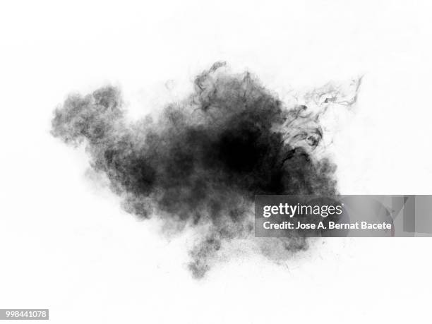 full frame of forms and textures of an explosion of powder and smoke of color gray and black on a white background. - bernat stock-fotos und bilder