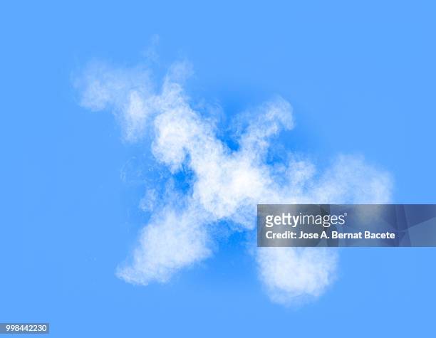 full frame of forms and textures of an explosion of powder and smoke of color white on a light blue background. - bernat bacete stock-fotos und bilder
