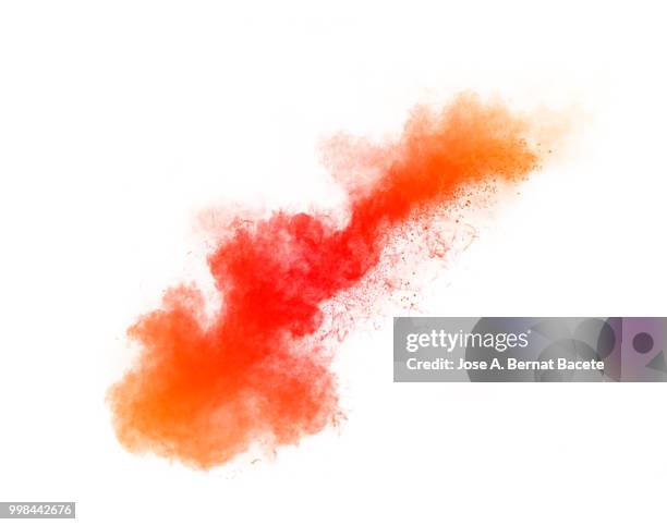 full frame of forms and textures of an explosion of powder and smoke of color red and orange on a white background. - bernat bacete stock-fotos und bilder