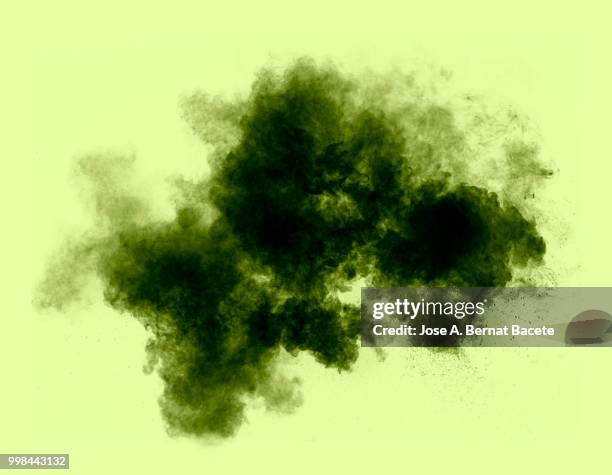 full frame of forms and textures of an explosion of powder and smoke of color gray and black on a 	pistachio green background. - bernat stock-fotos und bilder
