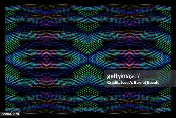 close-up abstract pattern of intertwined colorful light beams of color blue, green and pink on a  black background. - bernat bacete stock-fotos und bilder
