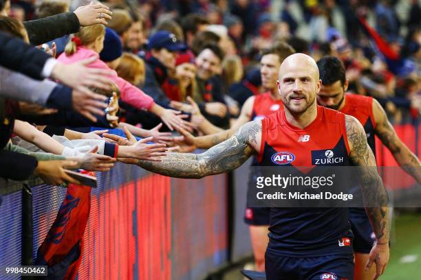 Nathan Jones of the Demons celebrates the win with fans during the round 17 AFL match between the Melbourne Demons and the Western Bulldogs at...