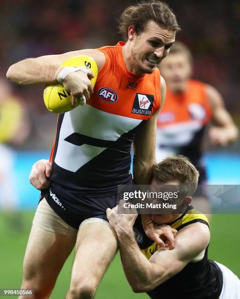 Phil Davis of the Giants is tackled by Jack Riewoldt of the Tigers during the round 17 AFL match between the Greater Western Sydney Giants and the...