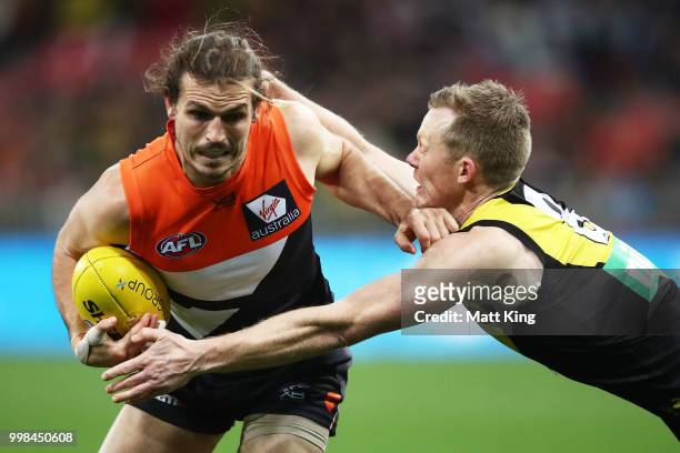 Phil Davis of the Giants is tackled by Jack Riewoldt of the Tigers during the round 17 AFL match between the Greater Western Sydney Giants and the...