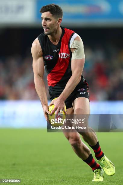 David Myers of the Bombers kicks during the round 17 AFL match between the Gold Coast Suns and the Essendon Bombers at Metricon Stadium on July 14,...