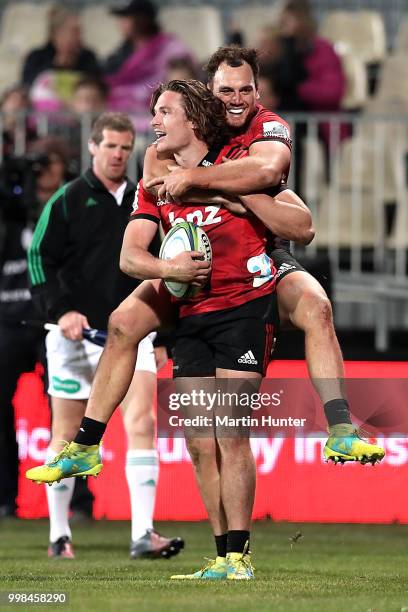 George Bridge of the Crusaders is congratulated by team mate Israel Dagg after scoring a try during the round 19 Super Rugby match between the...