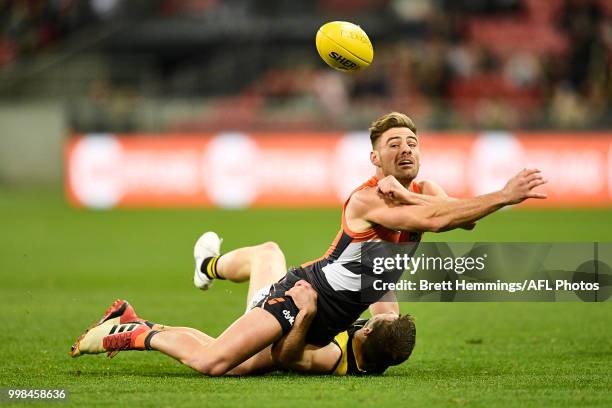 Stephen Coniglio of the Giants is tackled by Jack Higgins of the Tigers during the round 17 AFL match between the Greater Western Sydney Giants and...