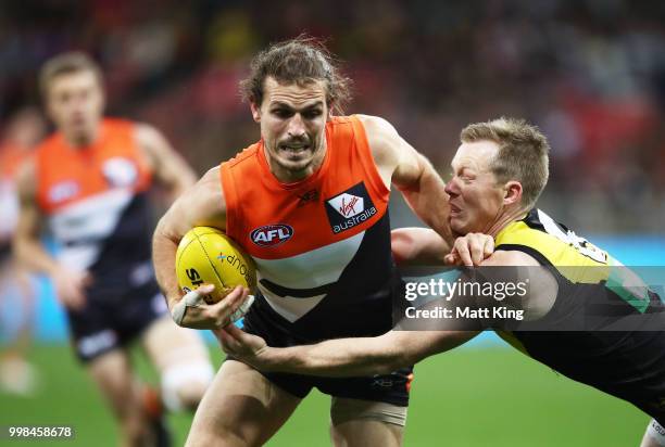 Phil Davis of the Giants is tackled by Jack Riewoldt of the Tigers during the round 17 AFL match between the Greater Western Sydney Giants and the...