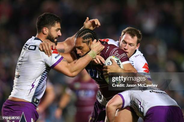 Martin Taupau of the Sea Eagles is tackled during the round 18 NRL match between the Manly Sea Eagles and the Melbourne Storm at Lottoland on July...