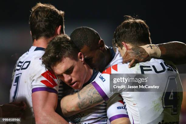 Brodie Croft of the Storm celebrates with team mates after scoring a try during the round 18 NRL match between the Manly Sea Eagles and the Melbourne...