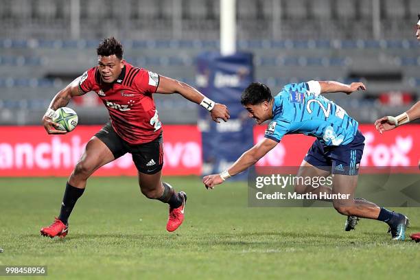 Seta Tamanivalu of the Crusaders breaks away from Tamati Tua of the Blues during the round 19 Super Rugby match between the Crusaders and the Blues...