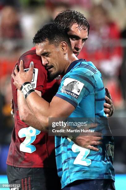 Sam Whitelock of the Crusaders embraces Jerome Kaino of the Blues after the round 19 Super Rugby match between the Crusaders and the Blues at AMI...