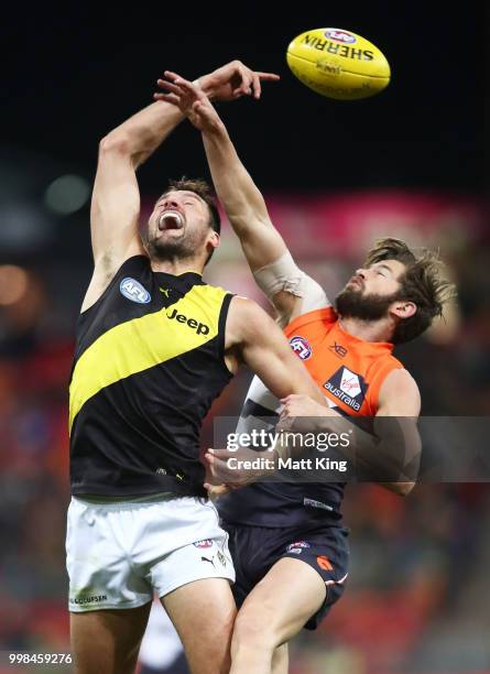 Toby Nankervis of the Tigers is challenged by Callan Ward of the Giants during the round 17 AFL match between the Greater Western Sydney Giants and...