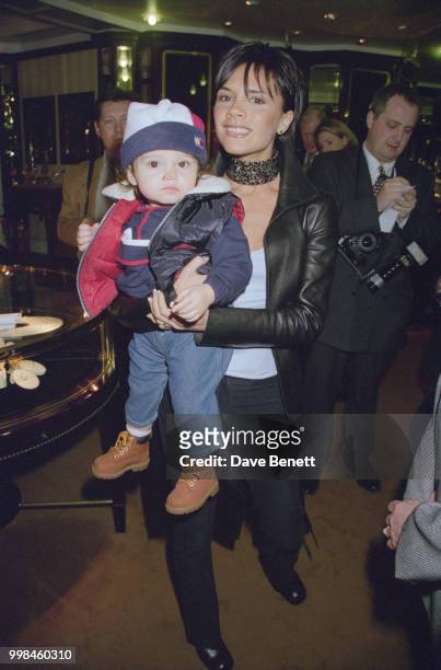 Spice Girls singer Victoria Beckham holding her niece in Bond Street to switch on the Christmas lights, London, 10th November 1999.