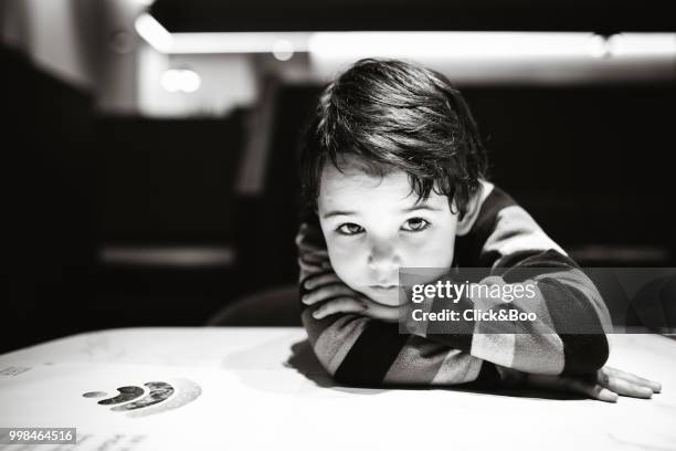 cute little boy indoors staring at the camera - click&boo stock pictures, royalty-free photos & images