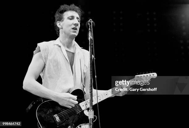 British musician Pete Townshend, of the Rock group the Who, plays guitar as he performs onstage at Shea Stadium, New York, New York, October 13, 1982.