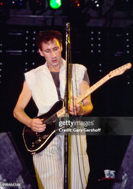 British musician Pete Townshend, of the Rock group the Who, plays guitar as he performs onstage at Shea Stadium, New York, New York, October 13, 1982.