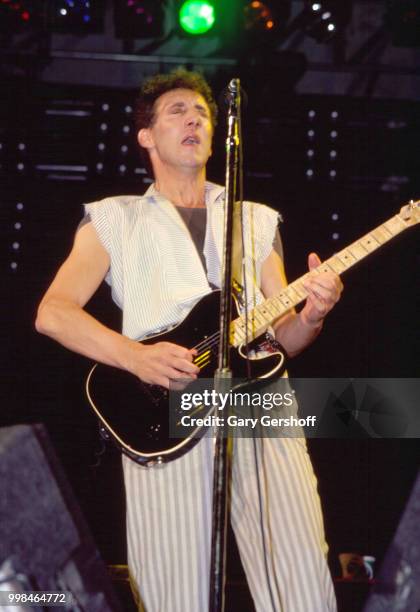 British musician Pete Townshend, of the Rock group the Who, plays guitar as he performs onstage at Shea Stadium, New York, New York, October 13, 1982.