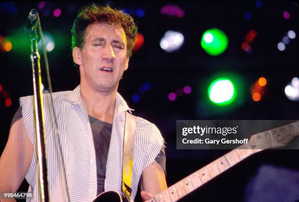 British musician Pete Townshend, of the Rock group the Who, plays guitar as he performs onstage at Shea Stadium, New York, New York, October 13, 1982.