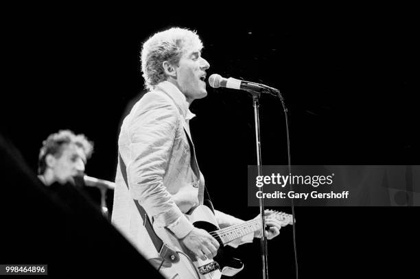 British musician Roger Daltrey, of the Rock group the Who, plays guitar as he performs onstage at Shea Stadium, New York, New York, October 13, 1982.
