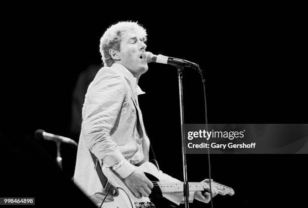 British musician Roger Daltrey, of the Rock group the Who, plays guitar as he performs onstage at Shea Stadium, New York, New York, October 13, 1982.