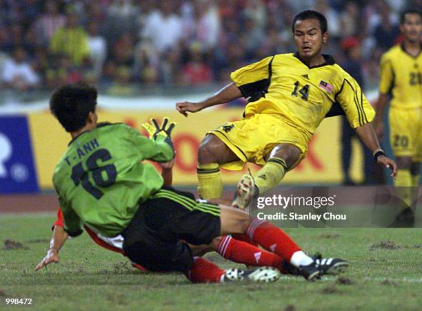 Akmal Rizal of Malaysia slots the ball pass Nguyen the Anh of Vietnam in a Group A Men's Under-23 Match between Malaysia and Vietnam held at the...