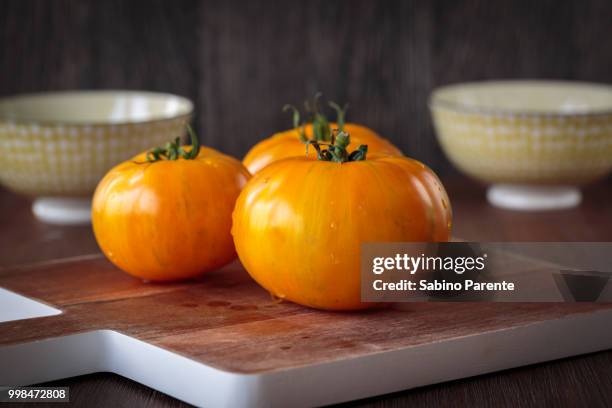 fresh raw yellow tomatoes - yellow tomatoes stock pictures, royalty-free photos & images