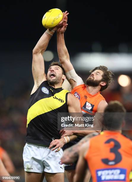 Toby Nankervis of the Tigers is challenged by Callan Ward of the Giants during the round 17 AFL match between the Greater Western Sydney Giants and...