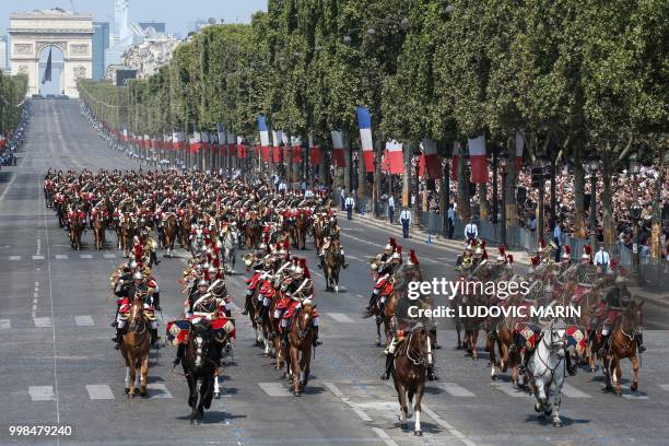 French Fanfare Mounted Republican guards take part in the annual Bastille Day military parade on the Champs-Elysees avenue as the Arch of Triumph in...