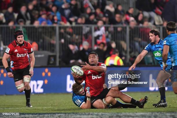 Andrew Makalio of the Crusaders offloads the ball during the round 19 Super Rugby match between the Crusaders and the Blues at AMI Stadium on July...